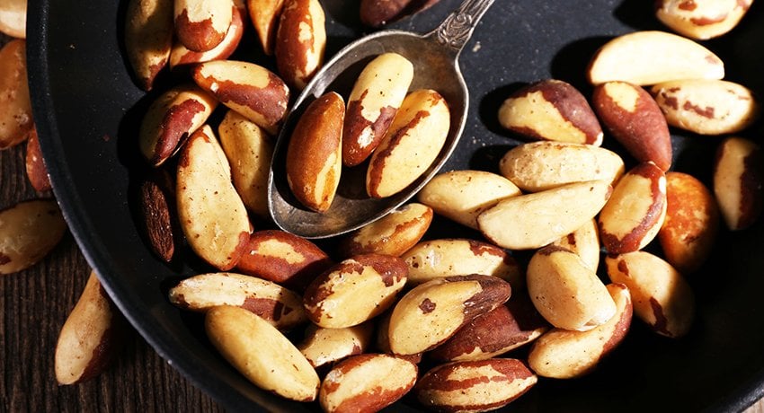 tasty brasil nuts in pan, close up