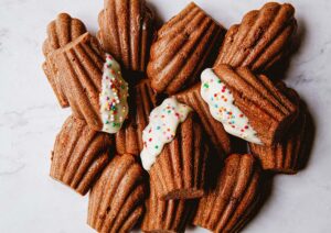 Chocolate Dipped Orange Madeleines - Sprinkle Bakes