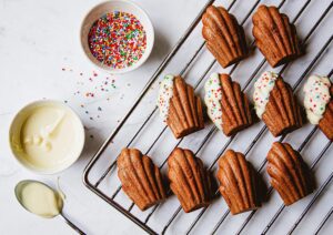 Chocolate Dipped Orange Madeleines - Sprinkle Bakes