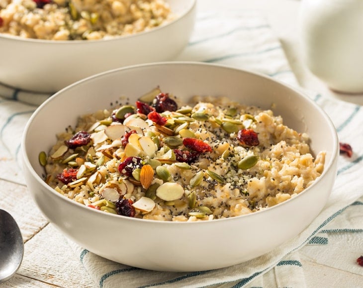 healthy-oatmeal-bowl-with-hulled-oat-groats-almonds-and-chia-seeds-min